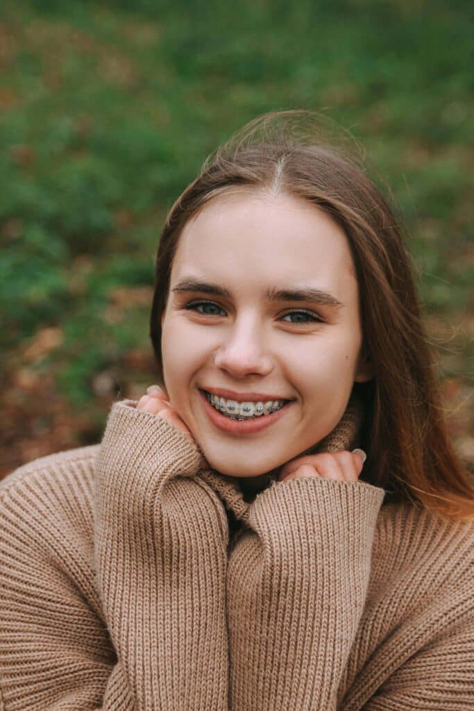 girl with tooth positioner